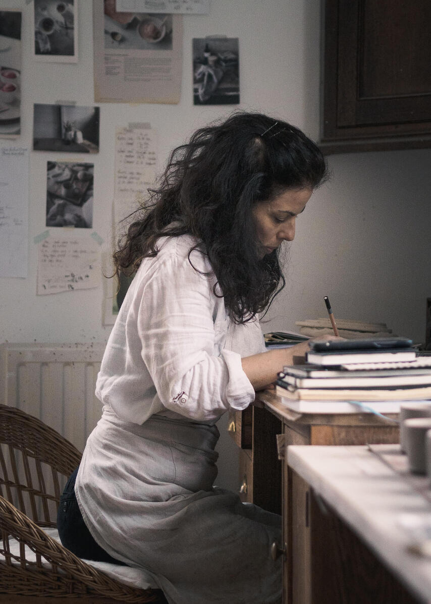 Creative business owner working at a desk in her studio